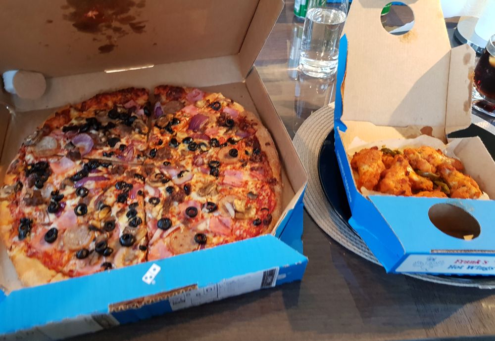 A Domino's pizza box, open