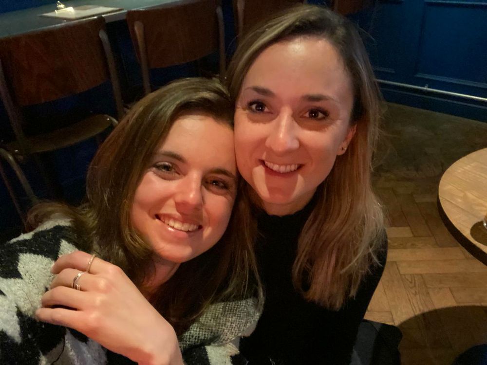 Becky and Giulia in a pub, cheek to cheek