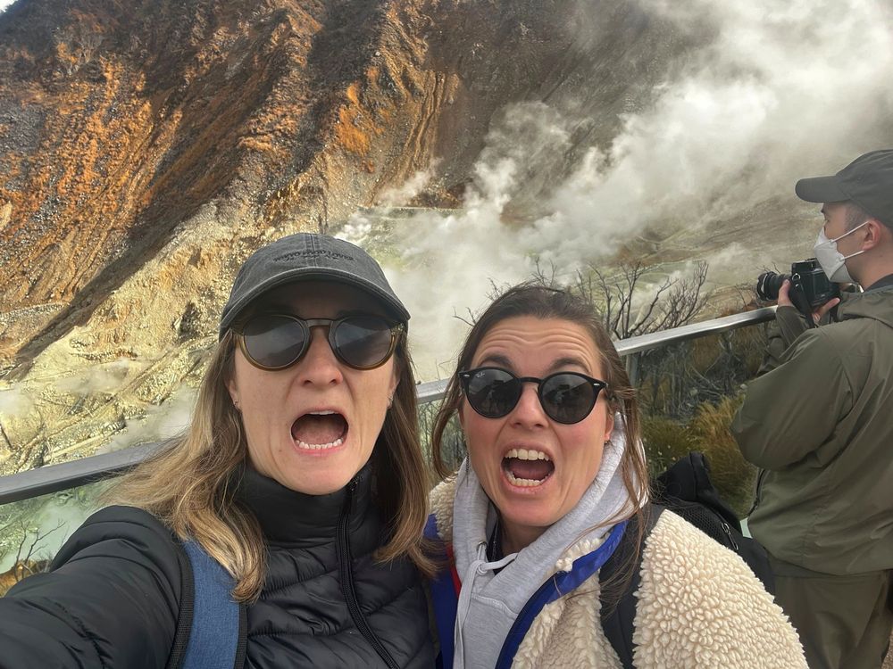 Becky and Giulia shouting in front of a volcano